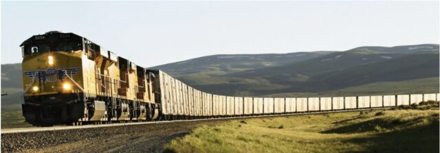 train with many boxcars on railroad tracks